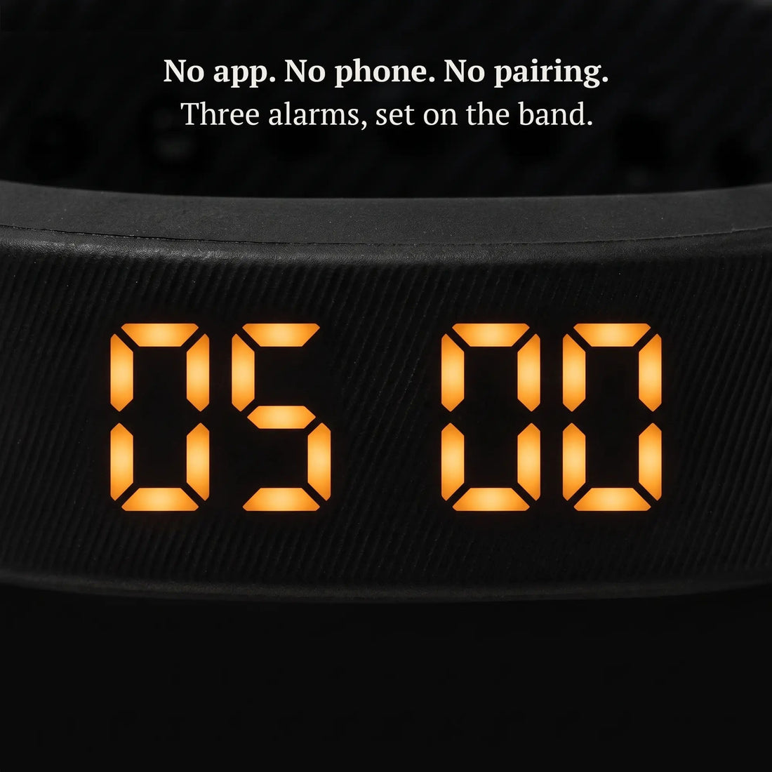 Close-up of the Sovune Nudge amber LED display showing the time, set on the band with no app