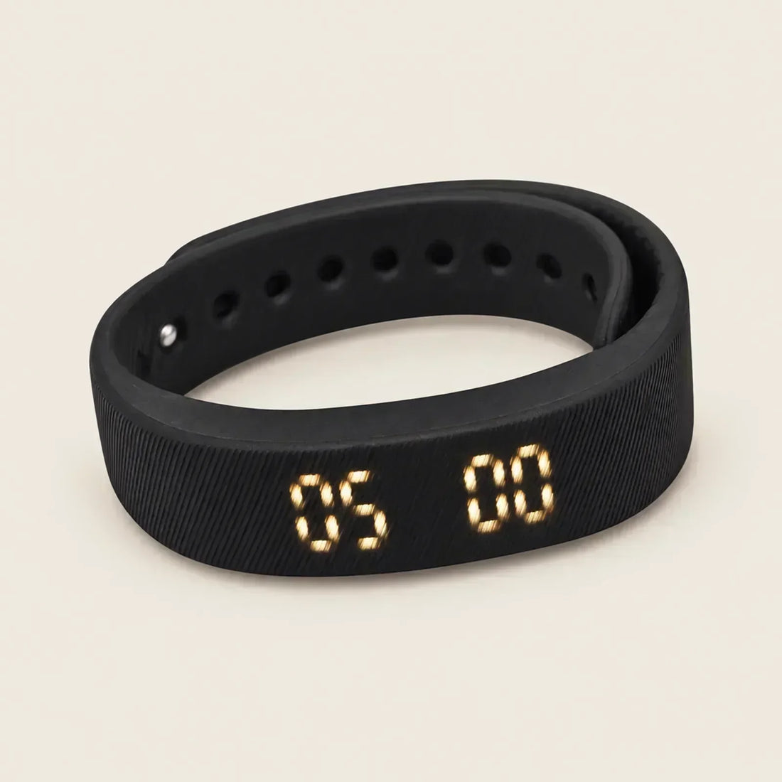 Sovune Nudge silent vibrating alarm wristband with its amber display showing 05:00