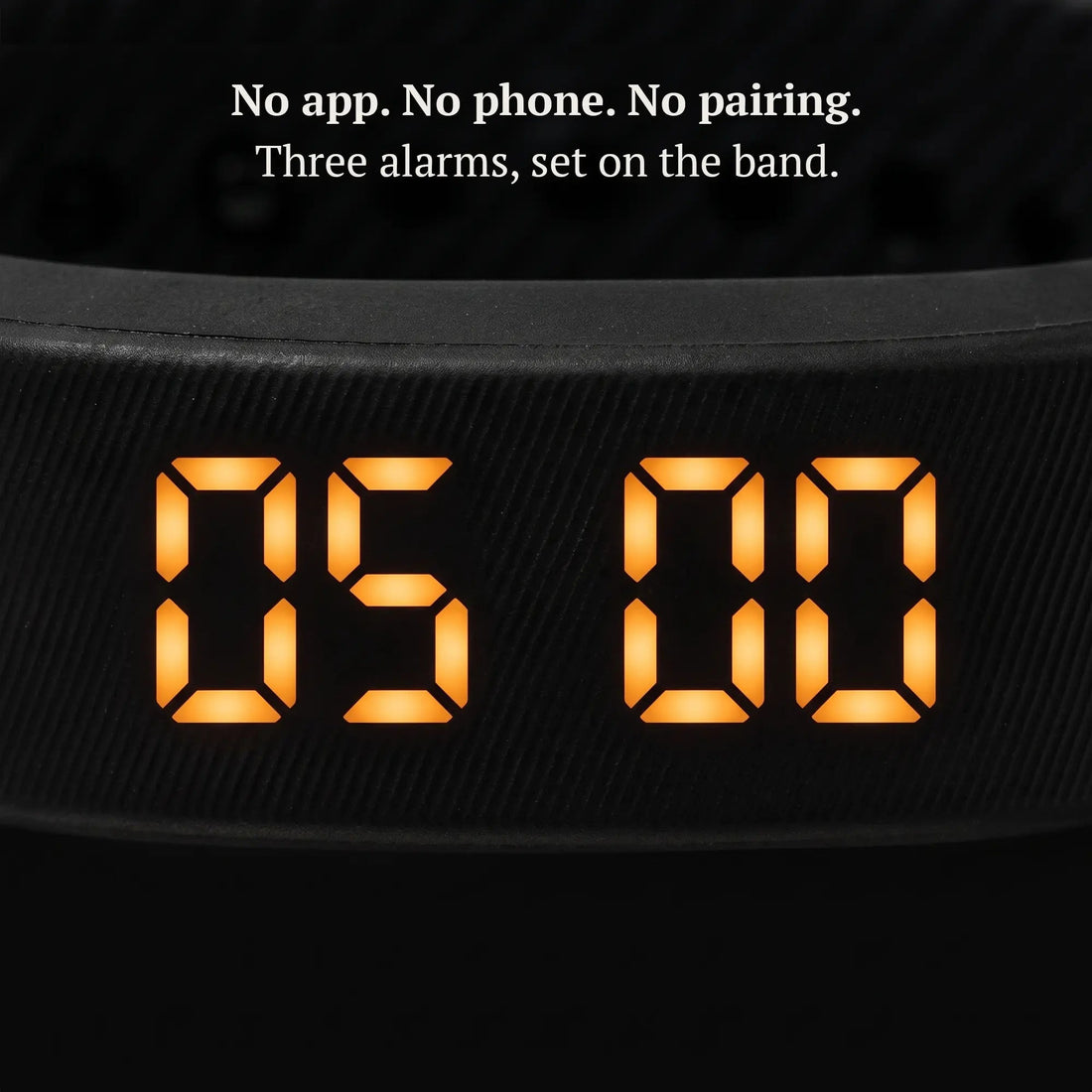Close-up of the Sovune Nudge amber LED display showing the time, set on the band with no app