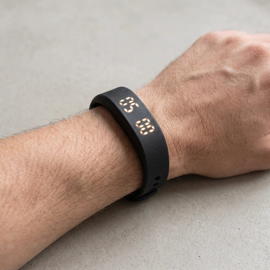 Sovune Nudge vibrating alarm wristband worn on a wrist in daylight