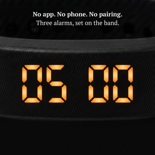 Close-up of the Sovune Nudge amber LED display showing the time, set on the band with no app